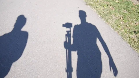 Shadow of camera man walking Stock Footage 74070397