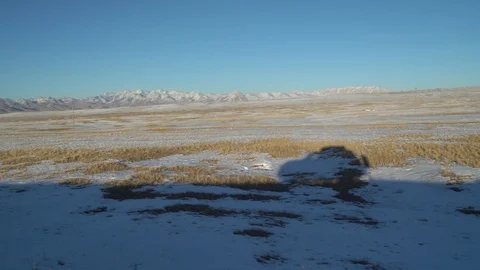 Shadow of a car driving along a road along the Pamir mountains Stock Footage 122238503