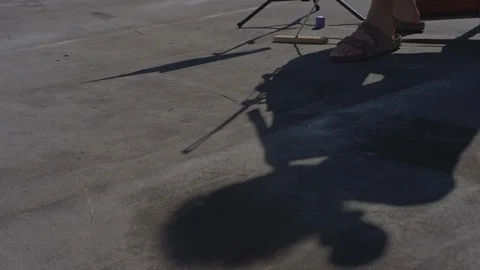 Shadow of cellist playing on New York rooftop Stock Footage 111042982