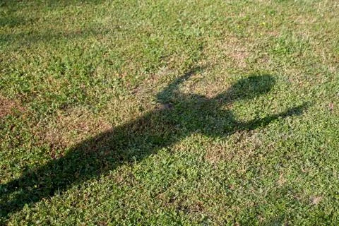 Shadow of a child in the grass Stock Photos
