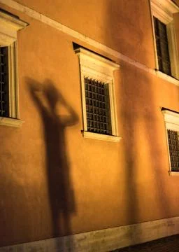 A shadow of a child standing in front of a facade Stock Photos