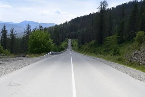 The shadow of a cloud on a mountain road in the Altai Mountains in summer Stock Photos