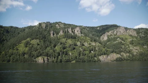 Shadow of clouds covered pine forest and rocks in mountains. White clouds and Video stock 174331697