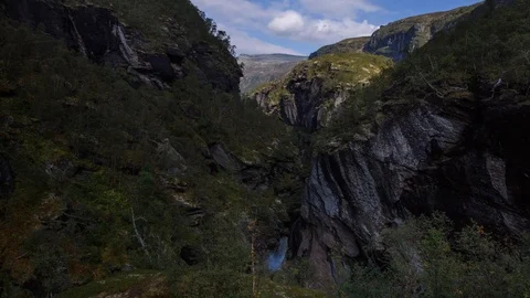 Shadow of clouds rolling across a valley. Timelapse wide shot, Norway Stock Footage 98185648