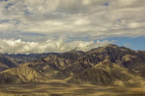 The shadow of the clouds on the slopes of the Himalayan mountains Stock Photos