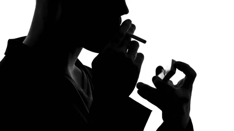 Shadow of confident man lighting cigarette and smoking, unhealthy lifestyle