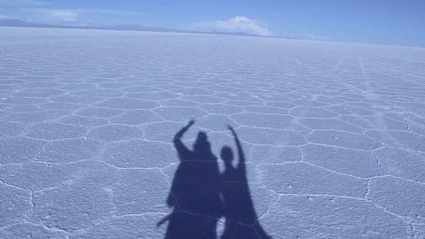 A shadow of a couple of backpackers in Salar of Uyuni. Motivation and Love. Stock Footage