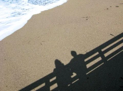 Shadow of couple on beach Stock Photos