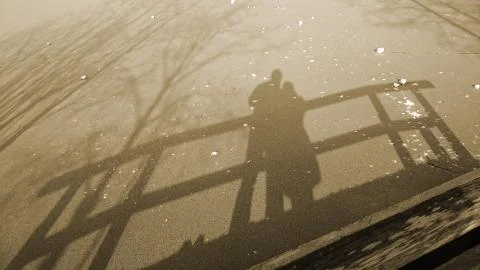 Shadow couple on a bridge Stock Photos