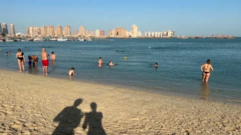 Shadow of a couple standing in the beach in Doha Qatar landscape of family Stock Footage 228597503