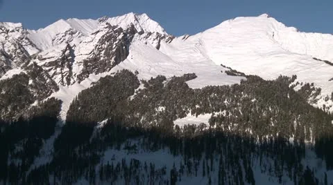 Shadow creeping up a snow covered mountain 스톡 동영상 10813007