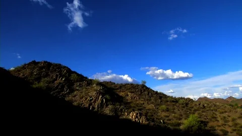 Shadow creeps over mountain as evening passes and sunsets in the west Stock Footage 75479515