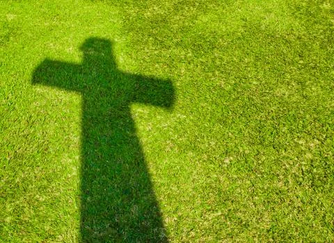 Shadow of cross on  green grass Stock Photos