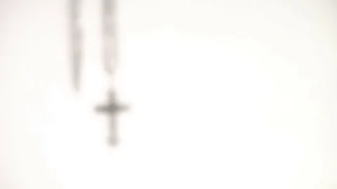 Shadow of a cross is swaying on a white background Stock Footage 73475710