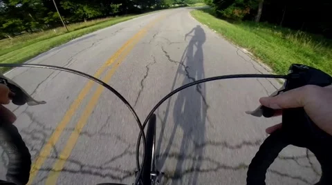 Shadow of cyclist over handlebar Stock Footage 40732583