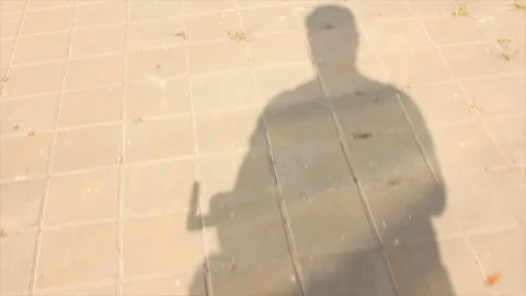 The shadow of a cyclist on the pavement Stock Footage 170759049