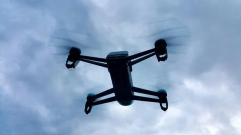Shadow drone flying in the cloudy sky Foto stock