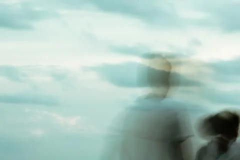 Shadow faces of people man and woman in front. Abstract motion blur backgroun Stock Photos