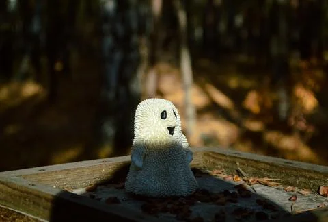 A shadow falls on a toy ghost standing sideways Stock-Fotos