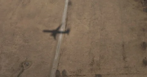 The shadow of a flying airplane on the ground. Stock Footage 91650445