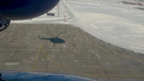 Shadow of flying helicopter. View from helicopter window to the ground Stock Footage 252501356