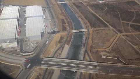 The shadow of flying plane on the ground on a sunny day. View from plane window. Video stock 331566509