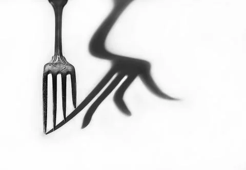 The shadow of the fork. Black and white photo. Stock Photos