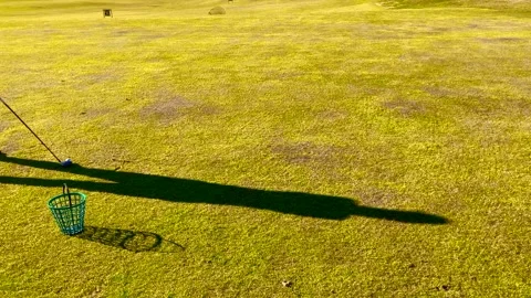 Shadow of a Golfer Training Golf Swing with 3 Wood on the Grass Stockbeeldmateriaal 191936198