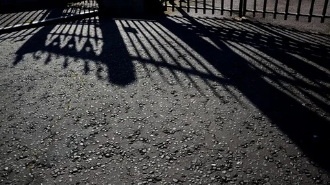 Shadow of grille moving along the pavement. Time Lapse Stock Footage 72379696