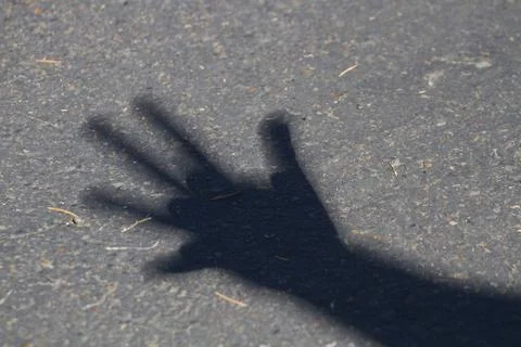 Shadow of a hand during a solar eclipse. Stock Photos