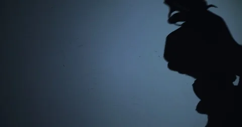 The shadow of hand loads the gun and prepares to kill someone Stock Footage 123505710