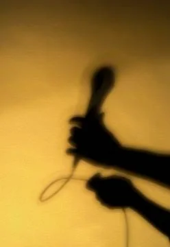 Shadow of hand with microphone Stock Photos
