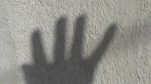 The Shadow of a Hand Projected Against a Wall, Creating a Unique Visual Видео 282593520