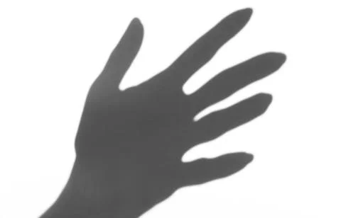 The shadow of the hand white background close-up Stock Photos