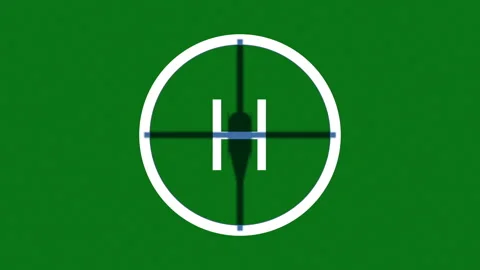 The shadow from the helicopter is approaching the landing zone on a green field. Stock Footage 127919356