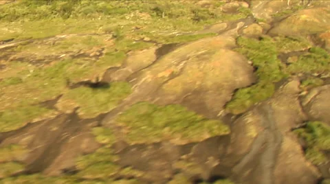 Shadow of helicopter moving over granite outcrops Stock Footage 53049624