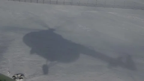 The shadow of a helicopter in the snow Stock Footage 163053556