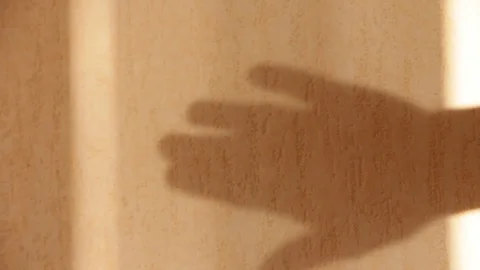 The shadow of a human hand against the wall Video stock 86634460