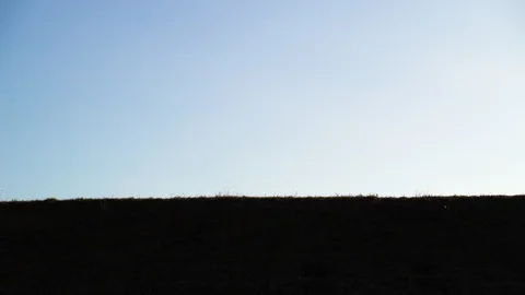 Shadow image of man riding kick scooter at public park, Zagreb, Croatia. Video stock 105503063