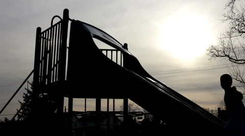 Shadow of kid waving on playground slide Stockbeeldmateriaal 5501801