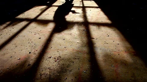 Shadow of a killer with a gun in his hand passing by the window Stock Footage 82755558