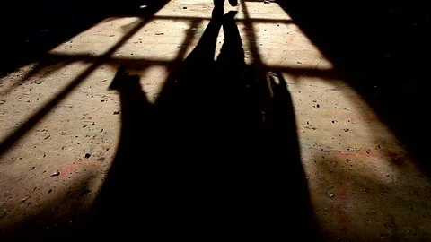 Shadow of a killer with a gun in his hand moving towards camera 動画素材 82761740