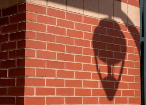 Shadow of a lantern on a brick wall Stock Photos