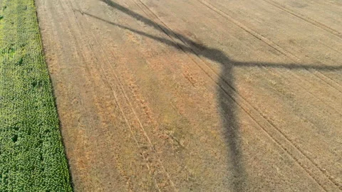 Shadow of large blades of a wind turbine. Stockbeeldmateriaal 166234741