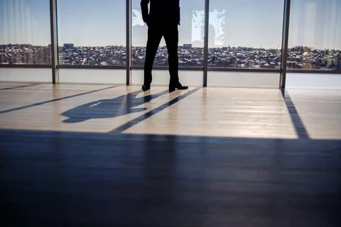 Shadow from a man against the background of a large window with the sun hitti Stock Photos