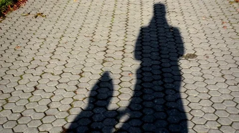 Shadow of a man and child on the sidewalk Stock-Footage 44023824
