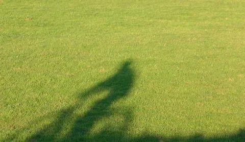 Shadow of man biking Foto stock