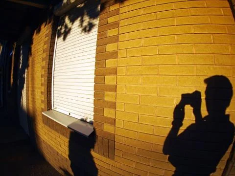 The shadow of a man with a camera in hand Stock Photos