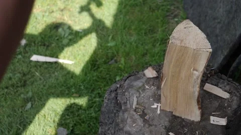 Shadow of man cutting piece of wood with the axe, slow motion Stock Footage 210249672