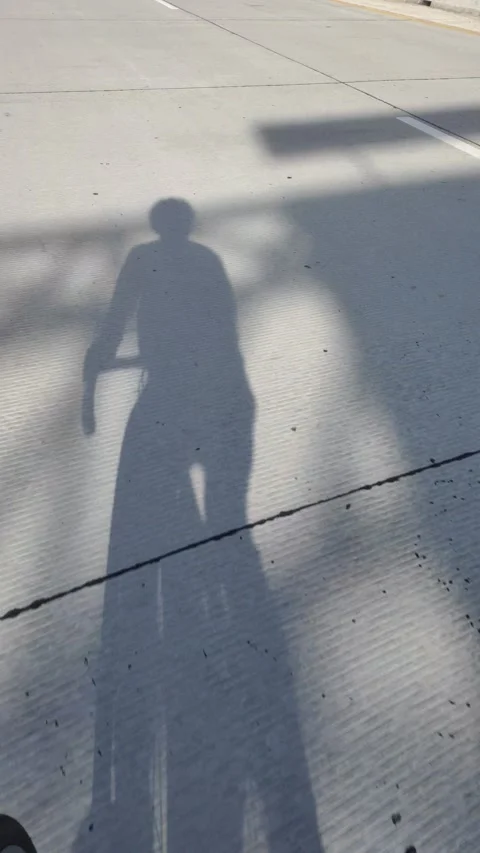Shadow of A Man Cycling Stock Footage 308133129